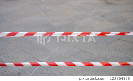 Red white signal tape. Warning of danger. No entry banner Red white signal tape. Warning of danger. No entry banner 122864556