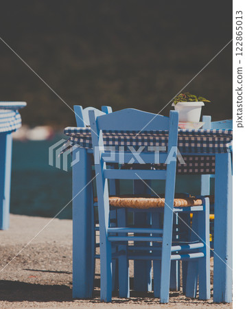 Open cafe outdoor restaurant in Greece on sea shore 122865013