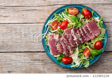 Salad with raw tuna , sesame and cherry tomatoes photography . Top view Salad with raw tuna , sesame and cherry tomatoes photography . Top view 122865226