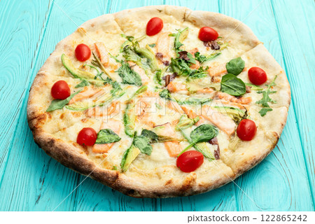 Italian pizza with avocado salmon  tomatoes and mozzarella photography. top view 122865242