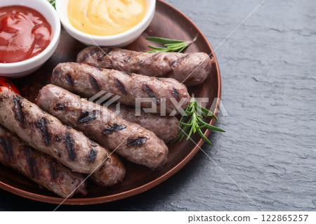 Grilled beef sausages with rosemary sauce and tomatoes photography . Top view 122865257