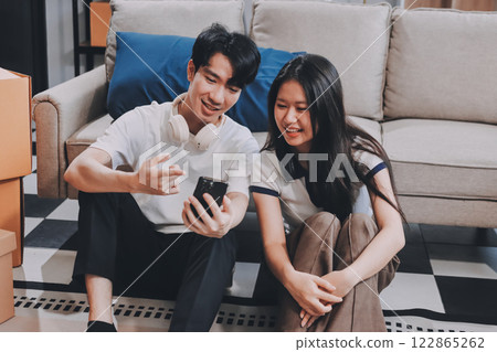 Smiling couple unpacking boxes in new house Smiling couple unpacking boxes in new house 122865262
