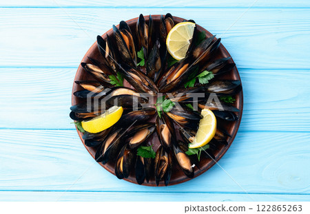 Mussels with parsley on a plate photography Mussels with parsley on a plate photography 122865263