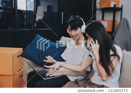Smiling couple unpacking boxes in new house Smiling couple unpacking boxes in new house 122865272