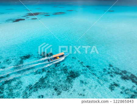 Aerial view of floating boat in clear turquoise water in summer 122865843