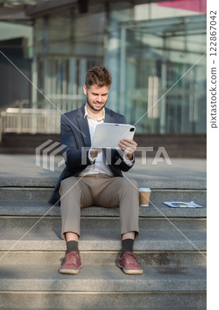 Businessman using a tablet to analysis graph company financial Businessman using a tablet to analysis graph company financial 122867042