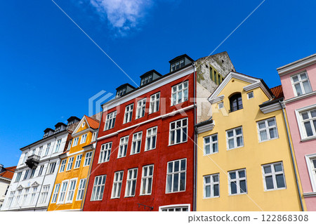 Nyhavn district in Copenhagen, Denmark. City center panoramic view of colorful houses. Nyhavn district in Copenhagen, Denmark. City center panoramic view of colorful houses. 122868308