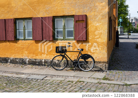 Beautiful view of old yellow houses in famous Nyboder district with a bikes. 122868388