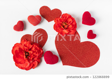 Spring composition on gray background of red knitted hearts, flowers red tulips with red heart shape made of paper for text. Happy Mother's Day greeting card, happy Valentine's Day, March 8, happy Spring composition on gray background of red knitted hearts, flowers red tulips with red heart shape made of paper for text. Happy Mother's Day greeting card, happy Valentine's Day, March 8, happy 122868899