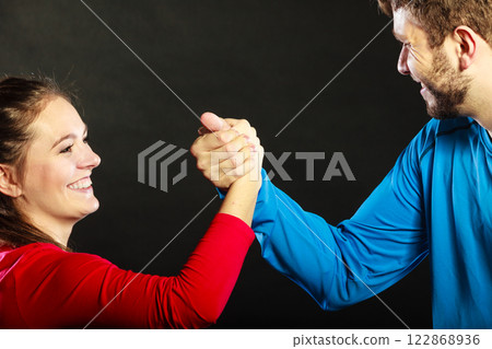 Friends man and woman clasping shaking hands. 122868936