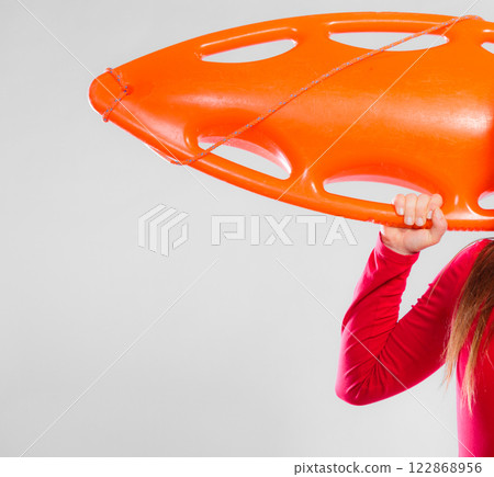 Girl lifeguard with equipment float Girl lifeguard with equipment float 122868956
