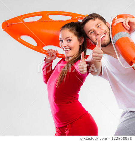 Happy lifeguard couple with equipment 122868958