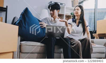 Smiling couple unpacking boxes in new house Smiling couple unpacking boxes in new house 122869401