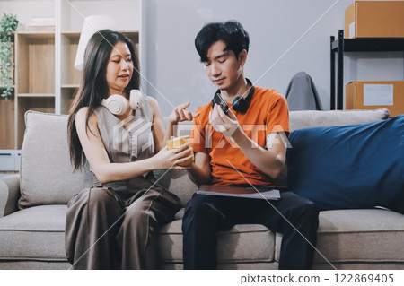 Smiling couple unpacking boxes in new house 122869405