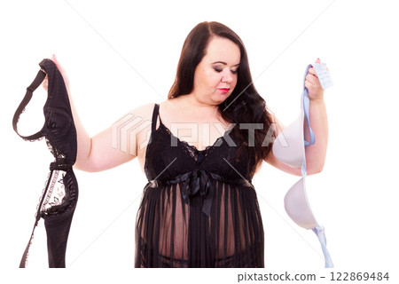 Woman choosing witch bra to wear. Woman choosing witch bra to wear. 122869484