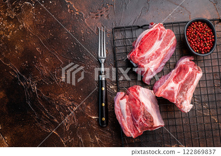 Thick Cut raw Beef Short Ribs, fresh meat with bone. brown background. top view 122869837