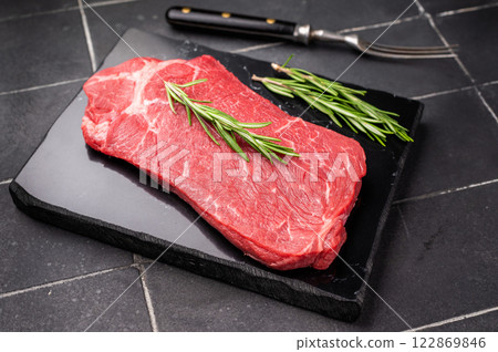 Delicious marbled Raw top sirloin beef steak with rosemary. black background. top view Delicious marbled Raw top sirloin beef steak with rosemary. black background. top view 122869846