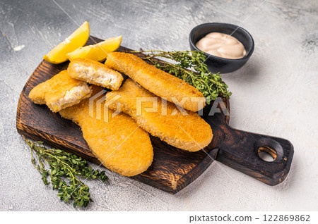 Deep fried Fish fingers on wooden board. white background. top view Deep fried Fish fingers on wooden board. white background. top view 122869862