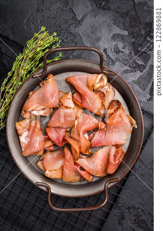 Italian Cured Prosciutto crudo ham. black background. top view 122869881