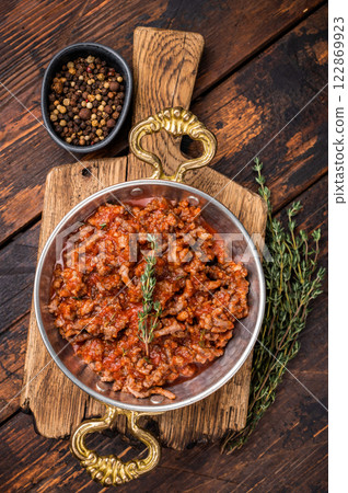 Bolognese Sauce, Authentic Italian meat and tomato pasta recipe. wooden background. top view Bolognese Sauce, Authentic Italian meat and tomato pasta recipe. wooden background. top view 122869923