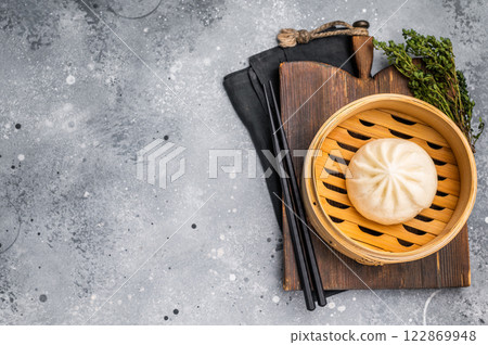 Chinese Bao or Baozi bun with meat in bamboo steamer. grey background. top view 122869948