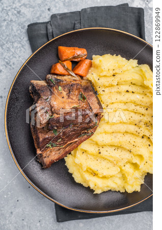 Slow cooked Beef short ribs, perfectly cooked and glazed with a rich barbecue sauce. grey background. top view 122869949