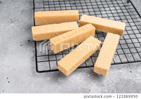 Dry Wafer stick biscuits with vanilla cream on a rack. grey background. top view 122869950