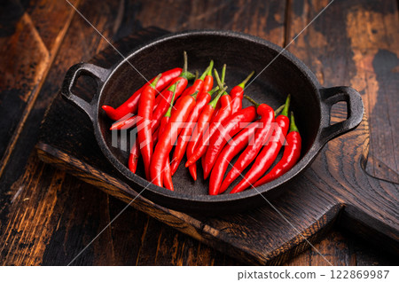 Freah Red chili peppers in a skillet isolated on white background. top view 122869987