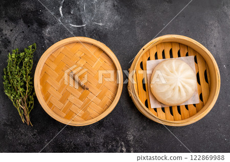 Chinese Bao or Baozi bun with meat in bamboo steamer. black background. top view Chinese Bao or Baozi bun with meat in bamboo steamer. black background. top view 122869988