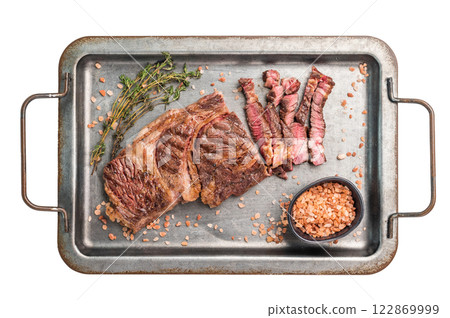 BBQ Grilled and sliced Chuck eye roll steak, marbled beef meat in a steel tray isolated on white background 122869999