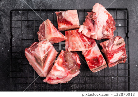Raw lamb mutton meat and bones for stew or goulash. black background. top view 122870018