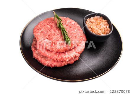 Raw veal and beef minced meat cutlets for burgers with herbs on plate isolated on white background Raw veal and beef minced meat cutlets for burgers with herbs on plate isolated on white background 122870078
