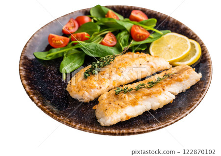 Roast Cod fish fiilets, white fish meat on plate with salad isolated on white background 122870102
