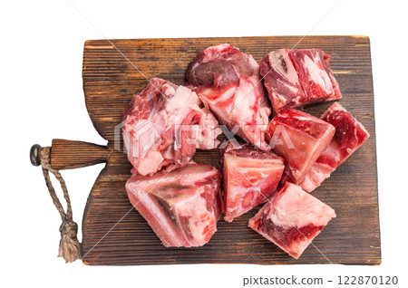 Raw diced Beef meat with bones for stew or goulash on wooden board isolated on white background. top view 122870120