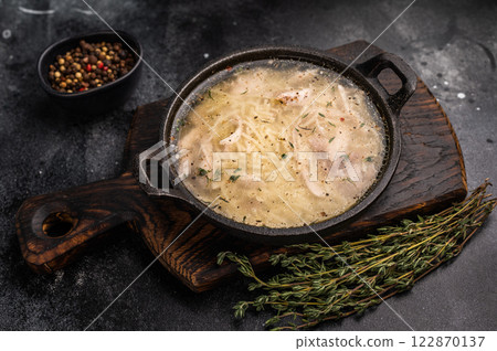 Chicken noodle soup with Vermicelli and meat in a bowl. black background. top view 122870137