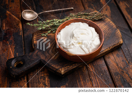 Dip sauce with Fresh Sour cream in a bowl. wooden background. top view Dip sauce with Fresh Sour cream in a bowl. wooden background. top view 122870142