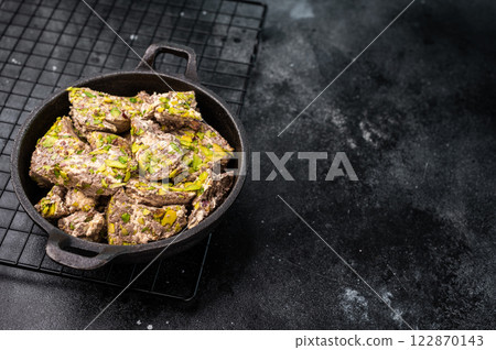 Oriental Halva with pistachio in a skillet. Natural vegan sweets. black background. top view. Oriental Halva with pistachio in a skillet. Natural vegan sweets. black background. top view. 122870143