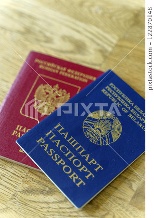 Belarusian and Russian passport. Citizenship of Russia and Belarus. Emigration, travel, work concept Belarusian and Russian passport. Citizenship of Russia and Belarus. Emigration, travel, work concept 122870148