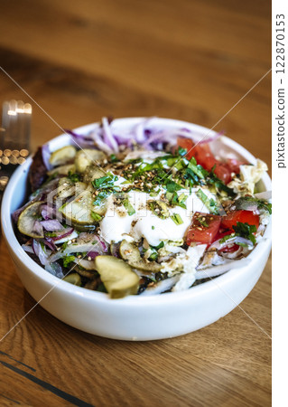 Salad bowl on wooden table background. Delicious healthy vegetable salad made from eco products Salad bowl on wooden table background. Delicious healthy vegetable salad made from eco products 122870153