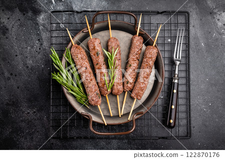Grilled minced beef and lamb kebabs skewers with fresh spices, arabic kofta kofte kebab. black background. top view 122870176