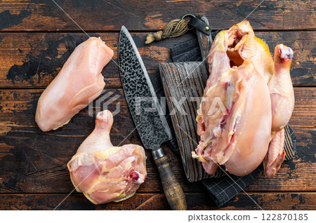 Fresh, raw chicken pieces on a wooden table Fresh, raw chicken pieces on a wooden table 122870185