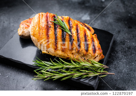 Grilled chicken breasts steaks with rosemary, farm poultry meat, top view, black background. 122870197