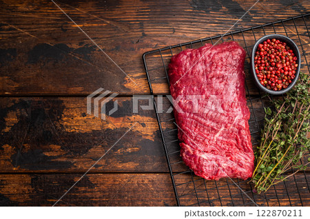 Raw flank steak, beef meat ready for BBQ. wooden background. top view 122870211