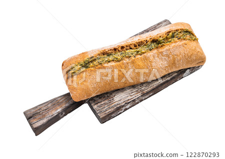 Garlic bread with herbs on wooden cutting board isolated on white background 122870293