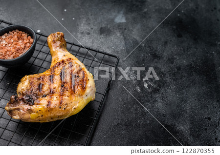 Grilled chicken leg with Thigh, roasted poultry meat on black background, top view Grilled chicken leg with Thigh, roasted poultry meat on black background, top view 122870355