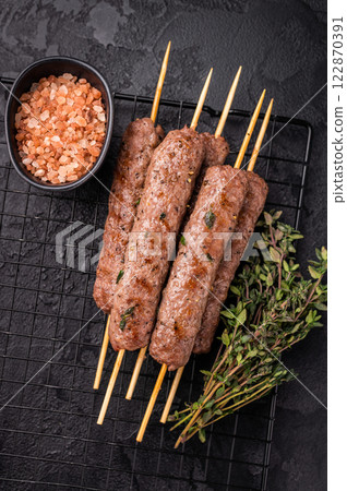Grilled Cevapcici skewers, Cevapi sausages from mince beef and pork meat. black background. top view Grilled Cevapcici skewers, Cevapi sausages from mince beef and pork meat. black background. top view 122870391