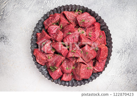 Ready for cooking Diced Raw kangaroo meat. white background. top view 122870423