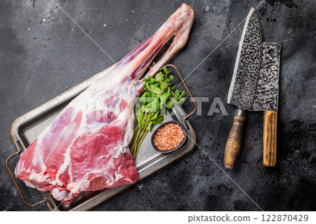 Uncooked whole mutton leg, raw organic lamb meat. black background. top view 122870429