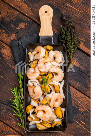 Seafood Cocktail appetiser with Mussels, Clams, Prawns, Shrimps and squid. wooden background. top view 122870433