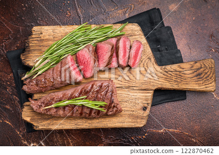 Grilled Lamb tenderloin steak, roast mutton fillet meat with herbs. brown background. top view 122870462